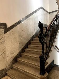 a staircase in a building with a metal railing at Appartamento Elegante Teatro Rossetti in Trieste