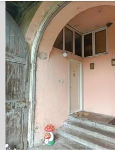 an entrance to a building with a door and a stuffed animal at Atelje Maravilja in Filmski Grad