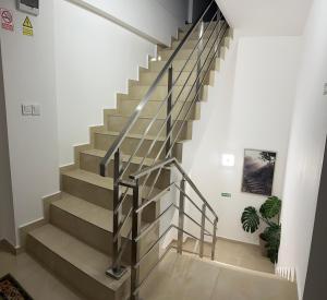 a staircase in a house with a metal railing at Gemasoti House in Drobeta-Turnu Severin