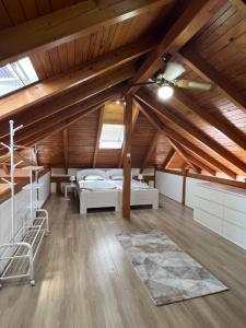 a attic room with two beds and a rug at Haus Palazzo in Bosanska Krupa