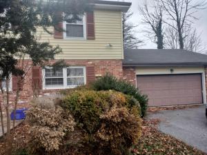 a house with a garage in front of it at Family Cozy House in Frederick