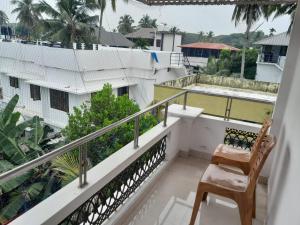 a balcony with a chair and a view of a building at Beena Homestay in Fort Kochi