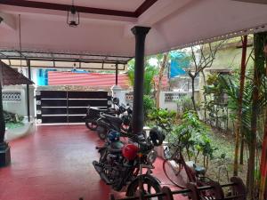 a row of motorcycles parked in a garage at Beena Homestay in Fort Kochi