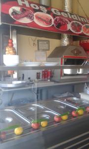 a kitchen with a counter with plates and food at Çiftlik otel 