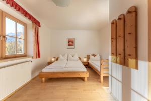 a bedroom with a bed and a window at Haus Diamant by Schladming-Appartements in Schladming