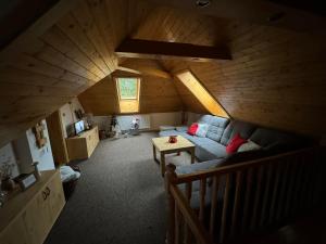 an attic room with a couch and a table at U Edyho in Zuberec