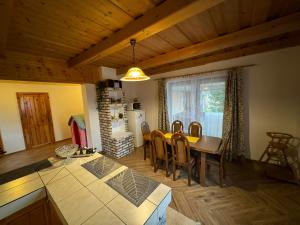 a kitchen and dining room with a table and chairs at U Edyho in Zuberec