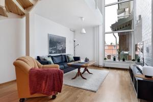 a living room with a couch and a table at Guestly Homes - 3BR City Charm in Piteå
