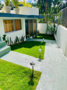 a house with a lawn in front of it at Cozy Studio in Private Villa in Las Terrenas