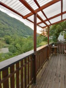 a deck with a view of the mountains at počitniška hiška MEDVEJKE in Slap ob Idrijci +11 photos