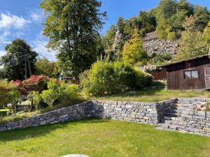 a stone retaining wall in the yard of a house at Hrdá Ves - Dům U Slunce in Vír