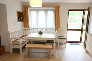 a room with a table and chairs and a window at Hrdá Ves - Dům U Slunce in Vír