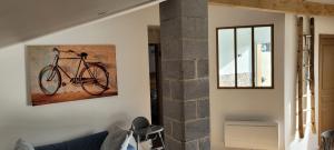 a painting of a bike hanging on a wall at le Wacapou in Courpignac +9 photos