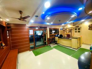 a living room with a blue ceiling and green floors at Mayur Paradise in Bangalore