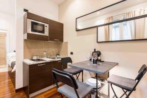 a kitchen with a table and chairs and a sink at Pantheon appartamento cestari in Rome +13 photos