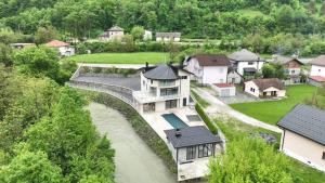 an aerial view of a house next to a river at Villa Majetic na Uni in Bihać