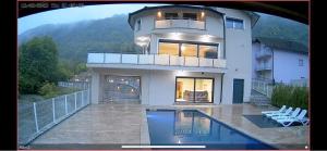 a large house with a swimming pool in front of it at Villa Majetic na Uni in Bihać