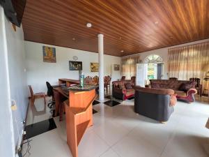 a living room with leather furniture and a wooden ceiling at European B & B Hotel in Bandarawela