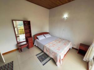 a small bedroom with a bed and a window at European B & B Hotel in Bandarawela