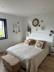 a white bedroom with a bed and a window at Nid de rêves jacuzzi en Provence in Châteaurenard