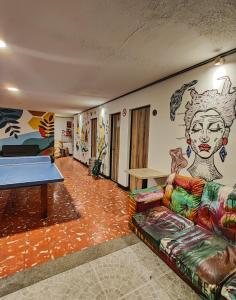 a room with a couch and a ping pong table at Zamia Hostel in Bucaramanga