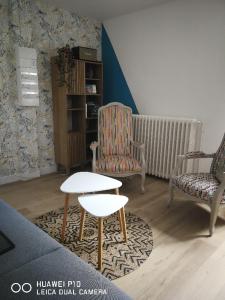 a living room with a chair and a coffee table at Chambre cosy de Bonabry in Fougères