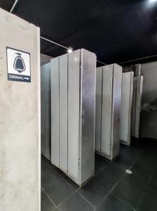 a row of refrigerators are lined up in a room at Zamia Hostel in Bucaramanga