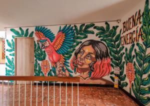 a wall with a mural of a woman and a bird at Zamia Hostel in Bucaramanga
