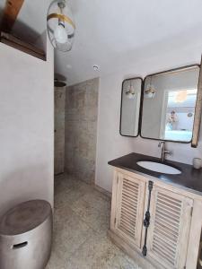 a bathroom with a sink and a mirror at Le Mas du Castellas 5* in Le Thor +15 photos