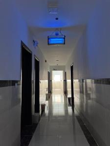 a hallway in a building with a blue light at مشتى الجنوب ( دخول ذكي ) in Salhabah