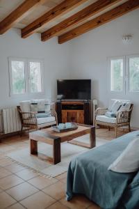 a living room with a couch and a coffee table at Finca S'Agret in Capdepera