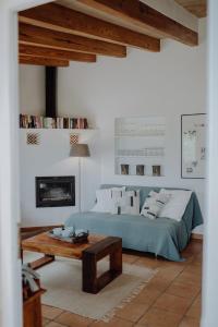 a bedroom with a bed and a coffee table at Finca S'Agret in Capdepera