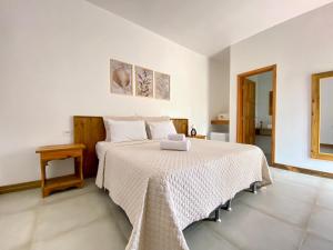 1 dormitorio con 1 cama grande con manta blanca en Porto Grande Hotel & Convention, en São Sebastião