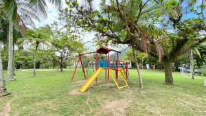 a playground with a slide in a park at Porto Grande Hotel & Convention in São Sebastião