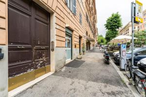 a street with cars parked next to a building at Modern Loft Trastevere in Rome