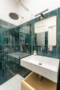a bathroom with a white sink and a mirror at Modern Loft Trastevere in Rome +10 photos