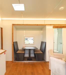 a dining room with a table and two chairs at Sleeptrailer in Zürich