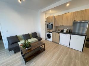 a living room with a couch and a kitchen at Paris Maurice Nordmann superbe 2 pièces in Paris