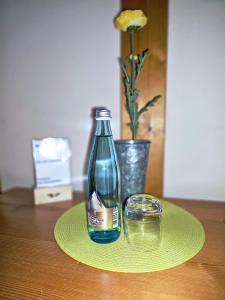 a bottle and a glass bowl on a table at Landgasthaus Sternen in Kehl am Rhein