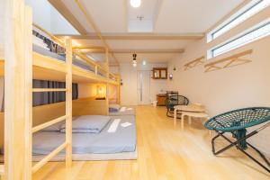 a room with bunk beds and a table and chairs at HAN'S EBISU - Shibuya - Entire House for Max 10 ppl in Tokyo