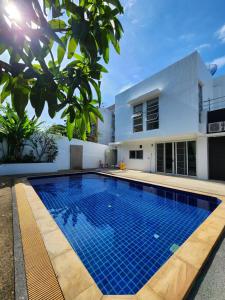 a swimming pool in front of a house at Rock Valley Private Pool Villa 3 Bedroom Phuket town in Ban Bang Khu