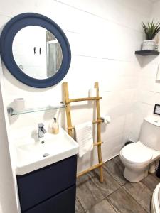 a bathroom with a sink and a mirror at 12a Mault-Ley Studio in St Ives
