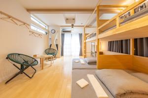 a room with bunk beds and a table and chairs at HAN'S EBISU - Shibuya - Entire House for Max 10 ppl in Tokyo