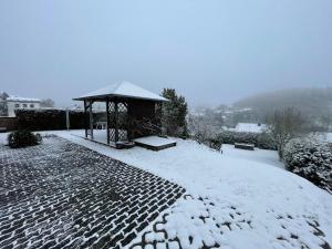 a gazebo with snow on the ground at Ferienwohnung Tina in Nettersheim