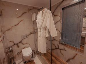 a bathroom with a toilet and a glass shower at Palmalife Hotel in Yalıkavak