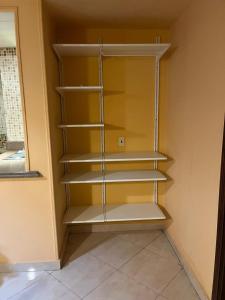 a closet with empty shelves in a room at Heliopolis Rock Residence in Cairo