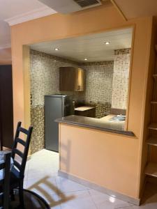 a kitchen with a counter and a refrigerator at Heliopolis Rock Residence in Cairo