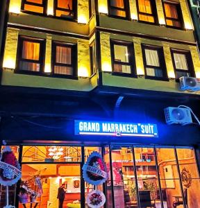 a store with a blue awning in front of a building at Grand Marrakech Hotel in Yıldırım