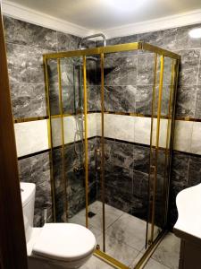 a bathroom with a shower and a toilet at Grand Marrakech Hotel in Yıldırım