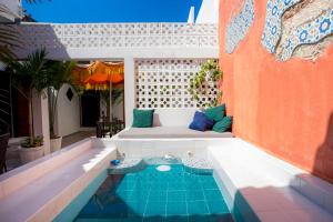 a patio with a couch and a swimming pool at Casa Moraira in Cartagena de Indias